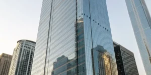 A brightly lit, modern commercial office building exterior, emphasizing the architectural design and quality of construction by MacDougall Pierce Construction. The building should have a clean, professional look.